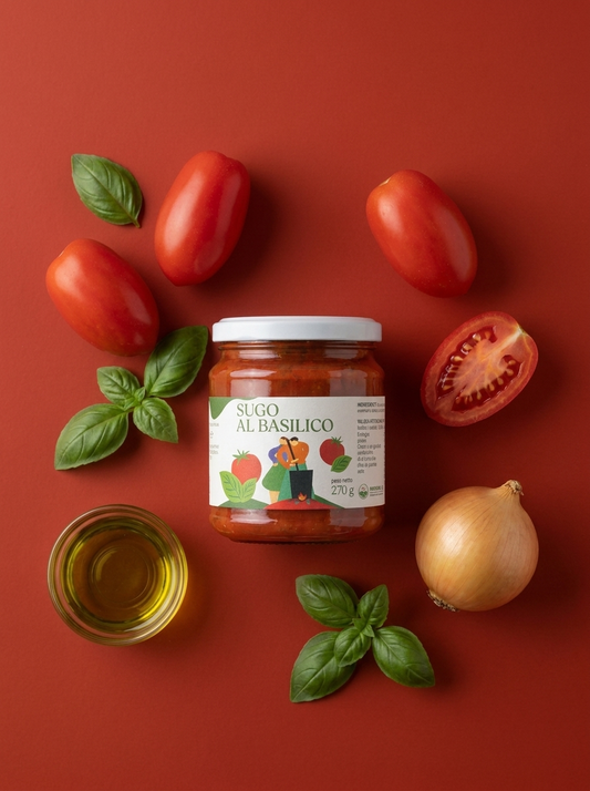 Sugo al Basilico Minnelea - vasetto su fondo rosso circondato dagli ingredienti